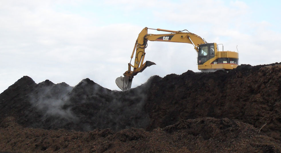 Excavator in soil yard